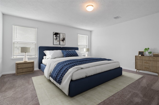 carpeted bedroom with a textured ceiling