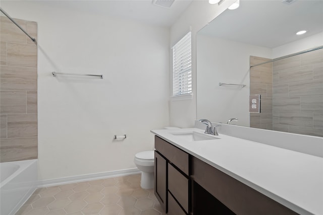 bathroom with toilet, vanity, and tile patterned floors