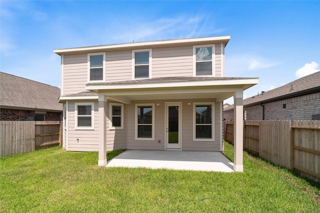 rear view of property featuring a patio and a lawn