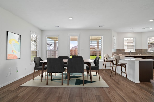 dining space with dark hardwood / wood-style flooring and sink