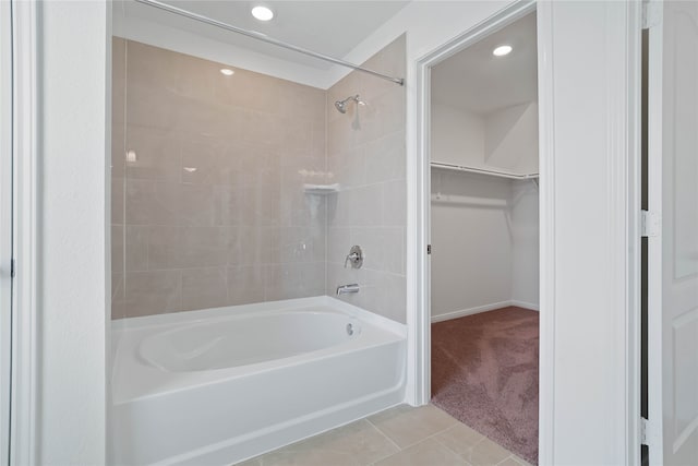 bathroom featuring tiled shower / bath combo and tile patterned floors