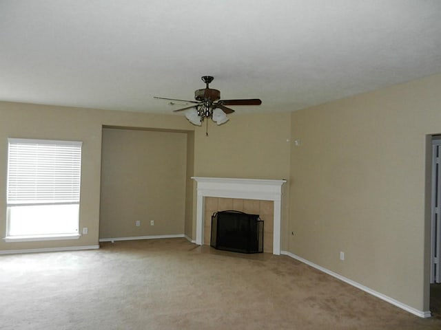 unfurnished living room with carpet flooring, ceiling fan, and a fireplace