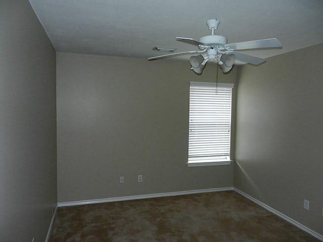 carpeted spare room featuring ceiling fan