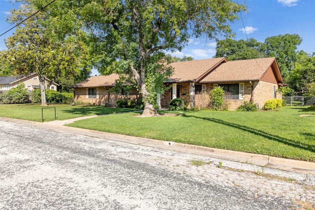 ranch-style house with a front lawn