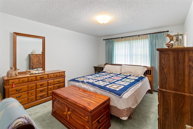 carpeted bedroom featuring a textured ceiling