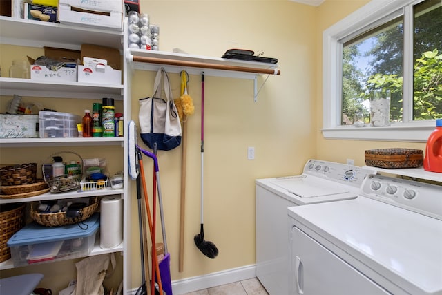 washroom featuring light tile flooring and washer and clothes dryer