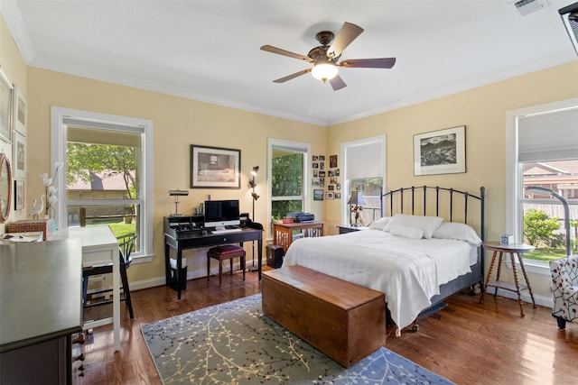 bedroom with ceiling fan, dark hardwood / wood-style flooring, and ornamental molding