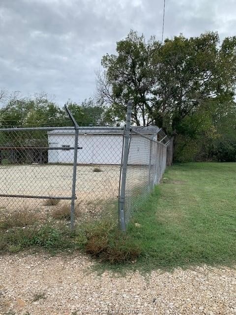 view of gate with a yard