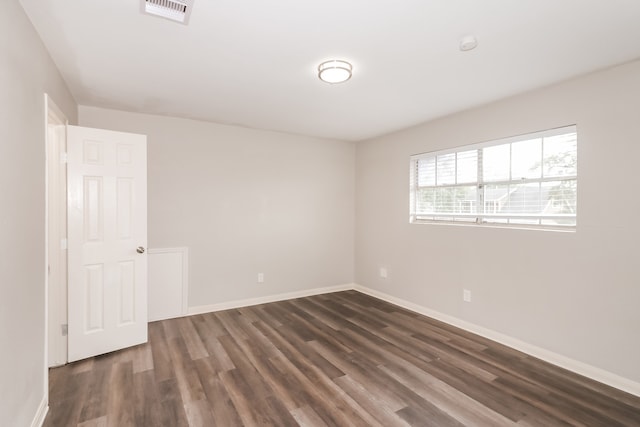 spare room with dark hardwood / wood-style floors