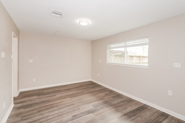 unfurnished room featuring hardwood / wood-style flooring