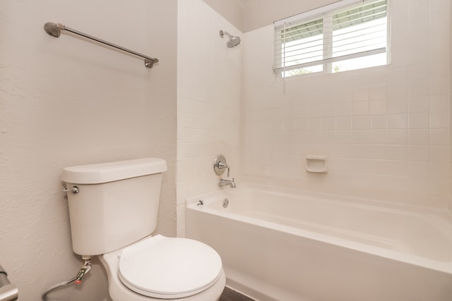 bathroom featuring toilet and shower / bathing tub combination