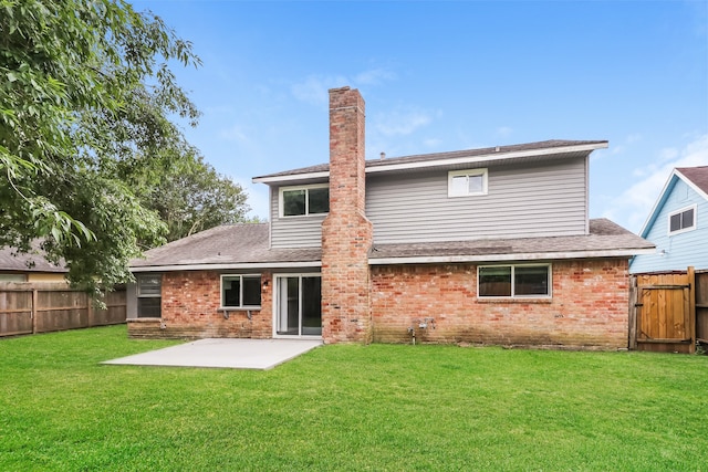 rear view of property featuring a yard and a patio