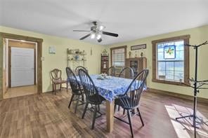 dining room with ceiling fan and dark hardwood / wood-style flooring