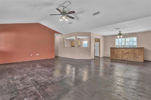 unfurnished living room with ceiling fan and vaulted ceiling