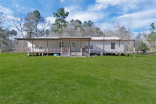 rear view of house with a pergola and a lawn