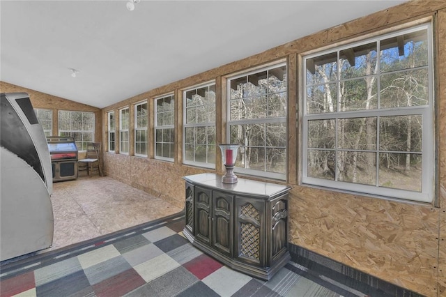 unfurnished sunroom with lofted ceiling