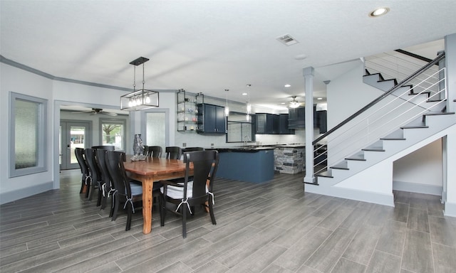 dining room with sink, light hardwood / wood-style flooring, and ceiling fan with notable chandelier