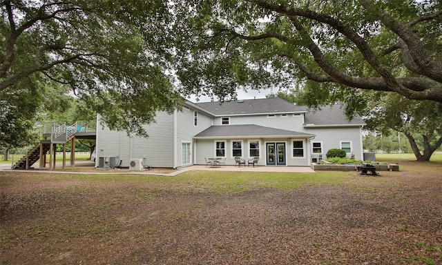 back of property with a patio and french doors