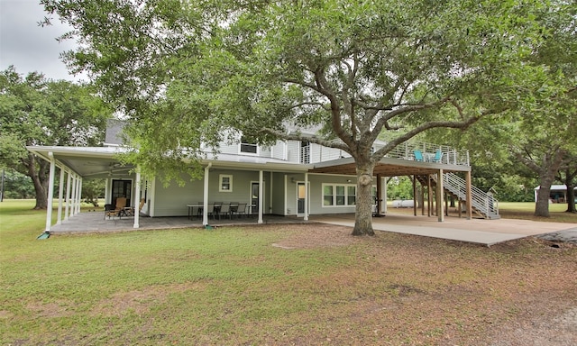 back of house with a yard, ceiling fan, and a patio area