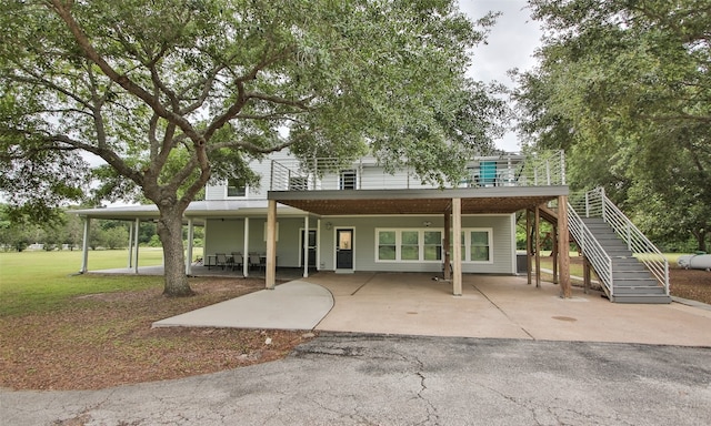 back of property featuring a yard and a patio