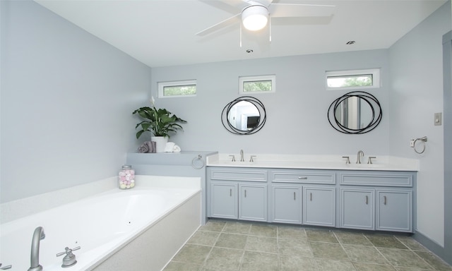 bathroom with tile floors, ceiling fan, a washtub, and dual bowl vanity