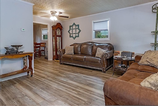 living room featuring crown molding, wood-type flooring, and ceiling fan