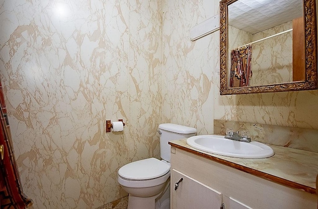 bathroom featuring vanity, toilet, and walk in shower