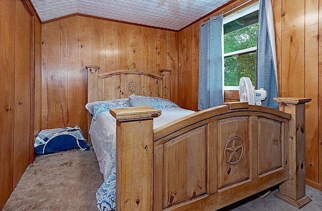 carpeted bedroom with crown molding and wood walls