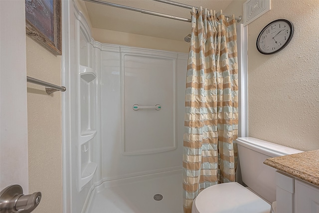 bathroom featuring a shower with shower curtain, vanity, and toilet