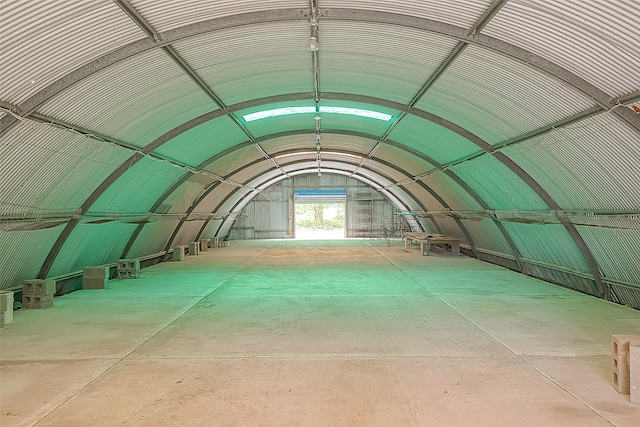 interior space with vaulted ceiling and concrete floors