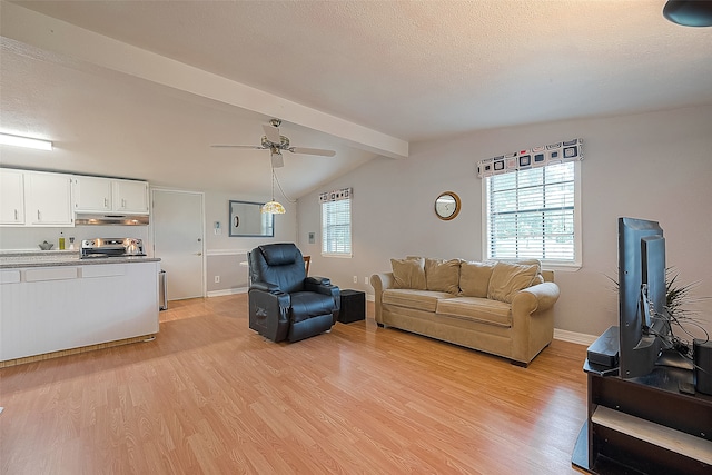 living room featuring ceiling fan, vaulted ceiling with beams, a textured ceiling, and light hardwood / wood-style flooring