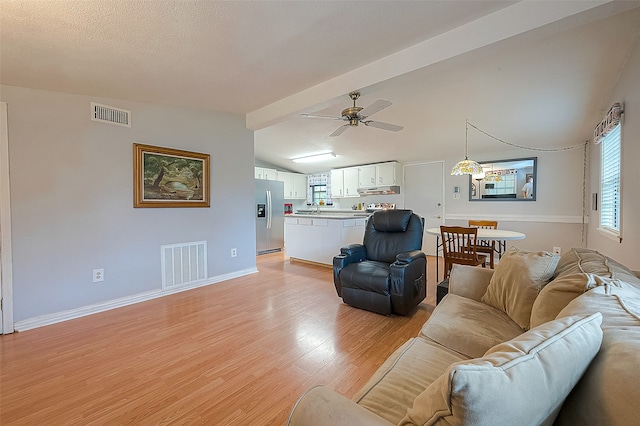 living room with light hardwood / wood-style floors, lofted ceiling with beams, sink, and ceiling fan