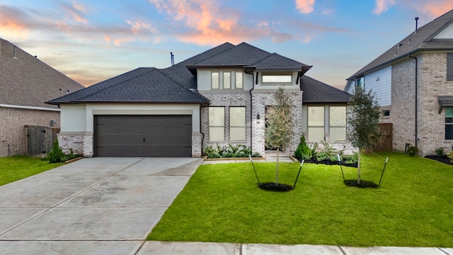 view of front of house with a garage and a lawn