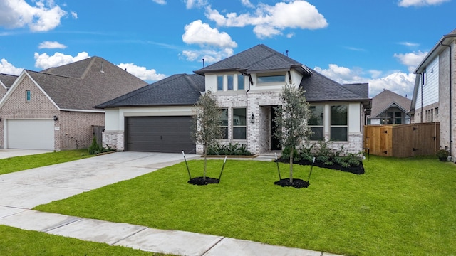 view of front of home with a front yard and a garage