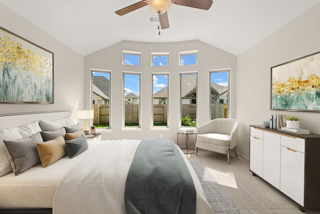 bedroom with ceiling fan, light carpet, and lofted ceiling