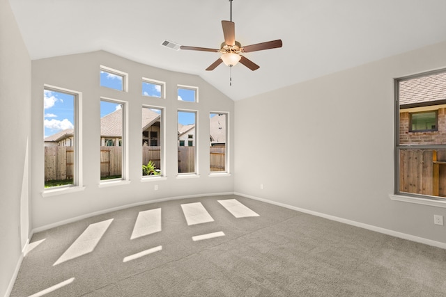 carpeted empty room featuring ceiling fan and lofted ceiling