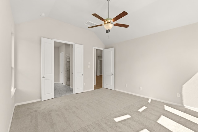 unfurnished bedroom featuring lofted ceiling, light colored carpet, and ceiling fan