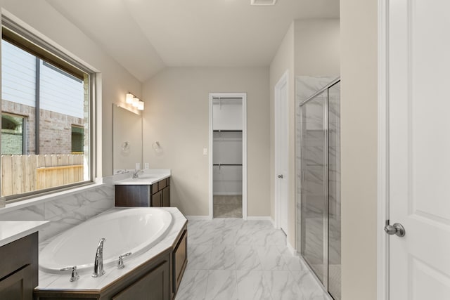 bathroom featuring vanity, lofted ceiling, and plus walk in shower