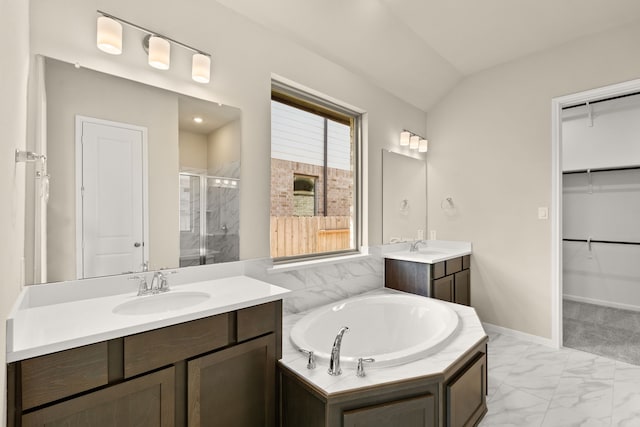 bathroom featuring vanity, lofted ceiling, and plus walk in shower