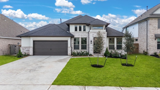 view of front of house featuring a front yard and a garage