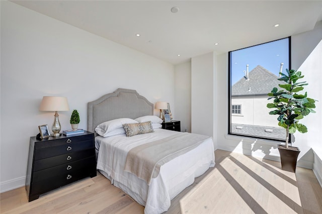 bedroom featuring recessed lighting, baseboards, and light wood-style floors