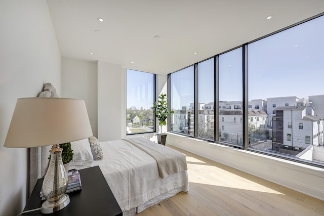 bedroom with recessed lighting and wood finished floors