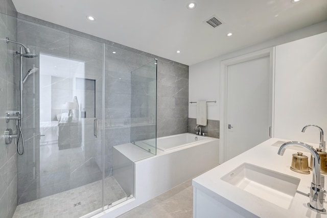 full bathroom featuring visible vents, a stall shower, a sink, recessed lighting, and a bath