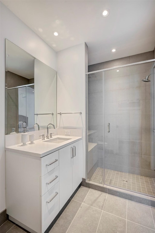 bathroom with vanity, a shower stall, and tile patterned flooring