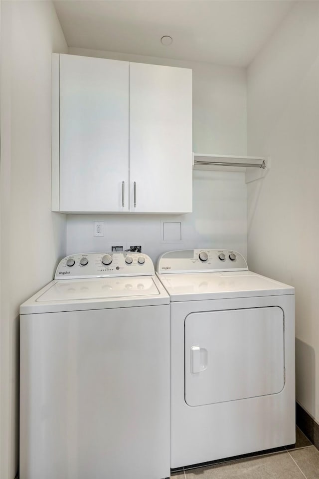 laundry room with separate washer and dryer and cabinet space