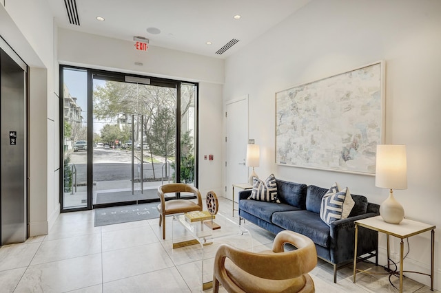 living room featuring light tile patterned floors, recessed lighting, and visible vents