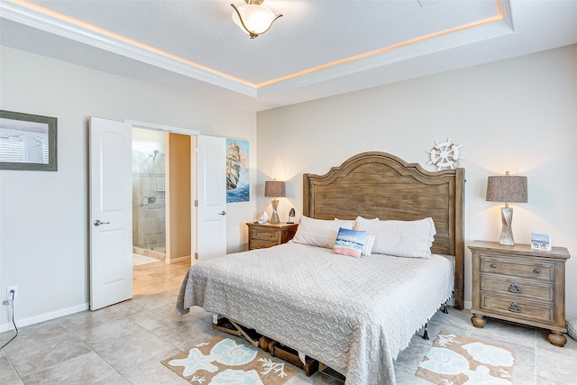 tiled bedroom featuring connected bathroom and a raised ceiling