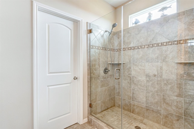 bathroom featuring walk in shower and tile floors