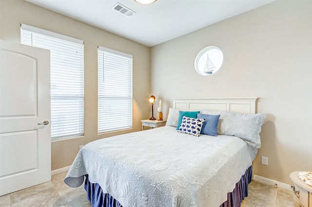 tiled bedroom with multiple windows