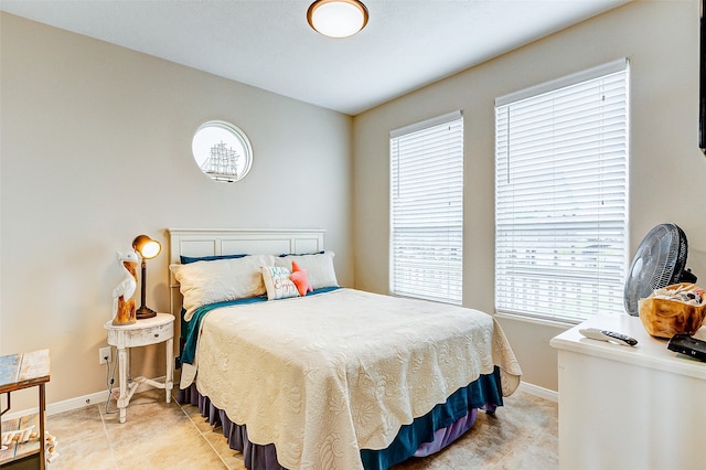 bedroom featuring tile floors and multiple windows